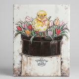 Chick on a bed of tulips on a vintage crock
