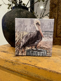 Pelican on a stump beach canvas art print