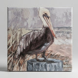 Pelican on a stump beach canvas art print