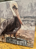 Pelican on a stump beach canvas art print