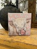 Whimsical cow blowing bubble, Highland canvas art print