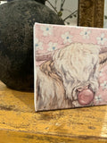 Whimsical cow blowing bubble, Highland canvas art print