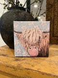 Highland cow blowing bubble canvas art print