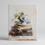 Teacup atop vintage books canvas art print