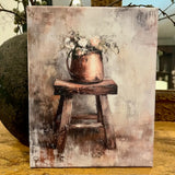 Florals in a copper pot on an old wooden stool
