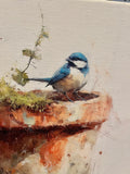 Bluebird perched on a clay pot canvas art print