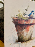 Bluebird perched on a clay pot canvas art print