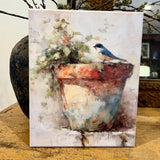 Bluebird perched on a clay pot canvas art print