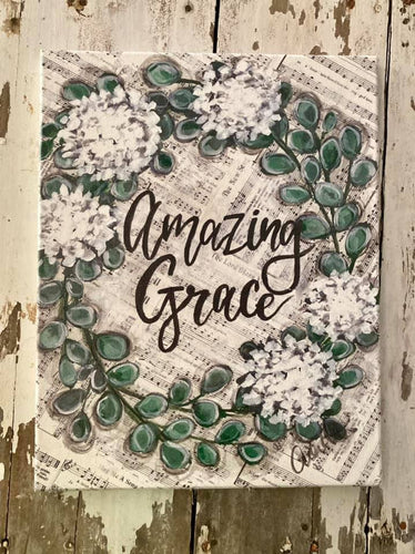Amazing grace sheet music with green wreath and white flowers on cavnas