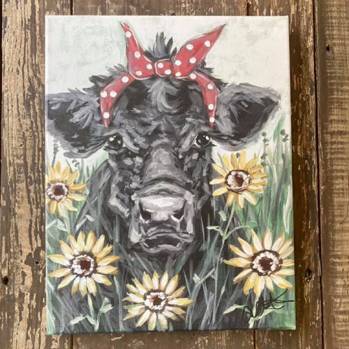 black and white cow wearing red and white polka dot bandana surrounded by sunflowers canvas